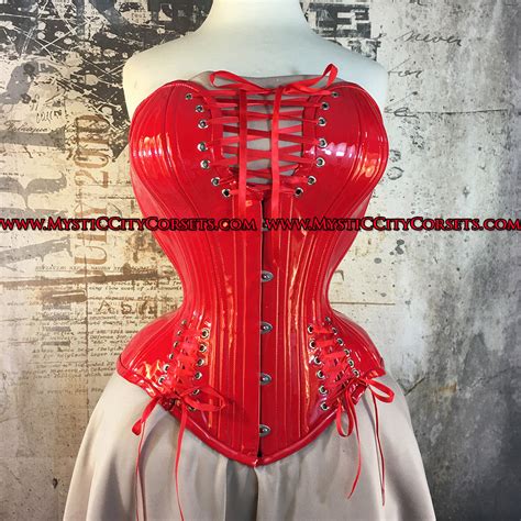 Mystic city corsets - MCC54 Red Brocade/Mesh Corset. $99.99. The MCC54 is designed for an hourglass silhouette. It includes 6 flat, and 20 spiral steel bones for higher reduction and support. This corset is designed with both tightlacing, and waist training needs in mind, suitable for everyday wear. The front measures 12” long, to provide coverage and tummy control. 
